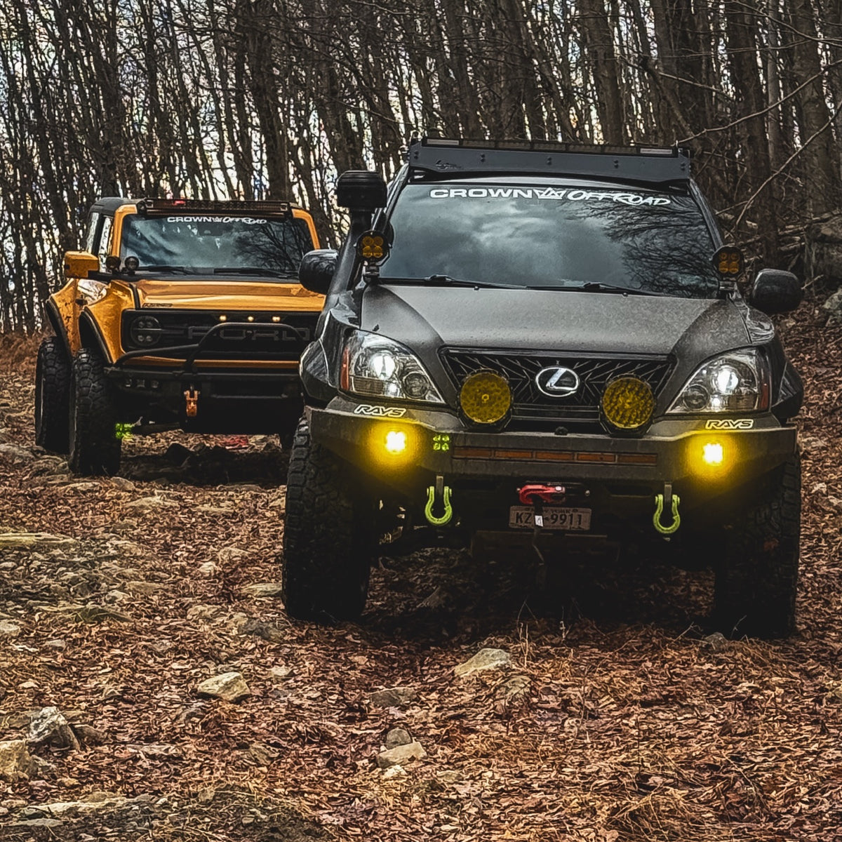 Crown Offroad Lexus and Ford Bronco together on a wooded trail