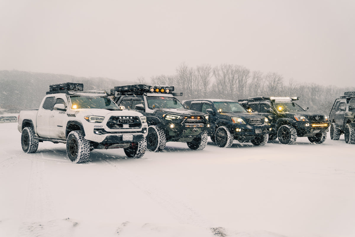 Off-road trucks together on a snow-covered trail