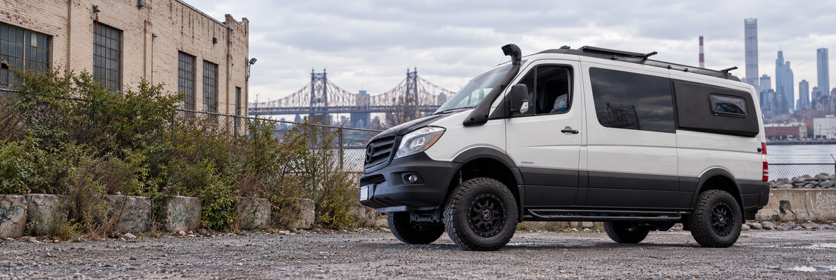 White lifted camper van in an outdoor New York industrial setting